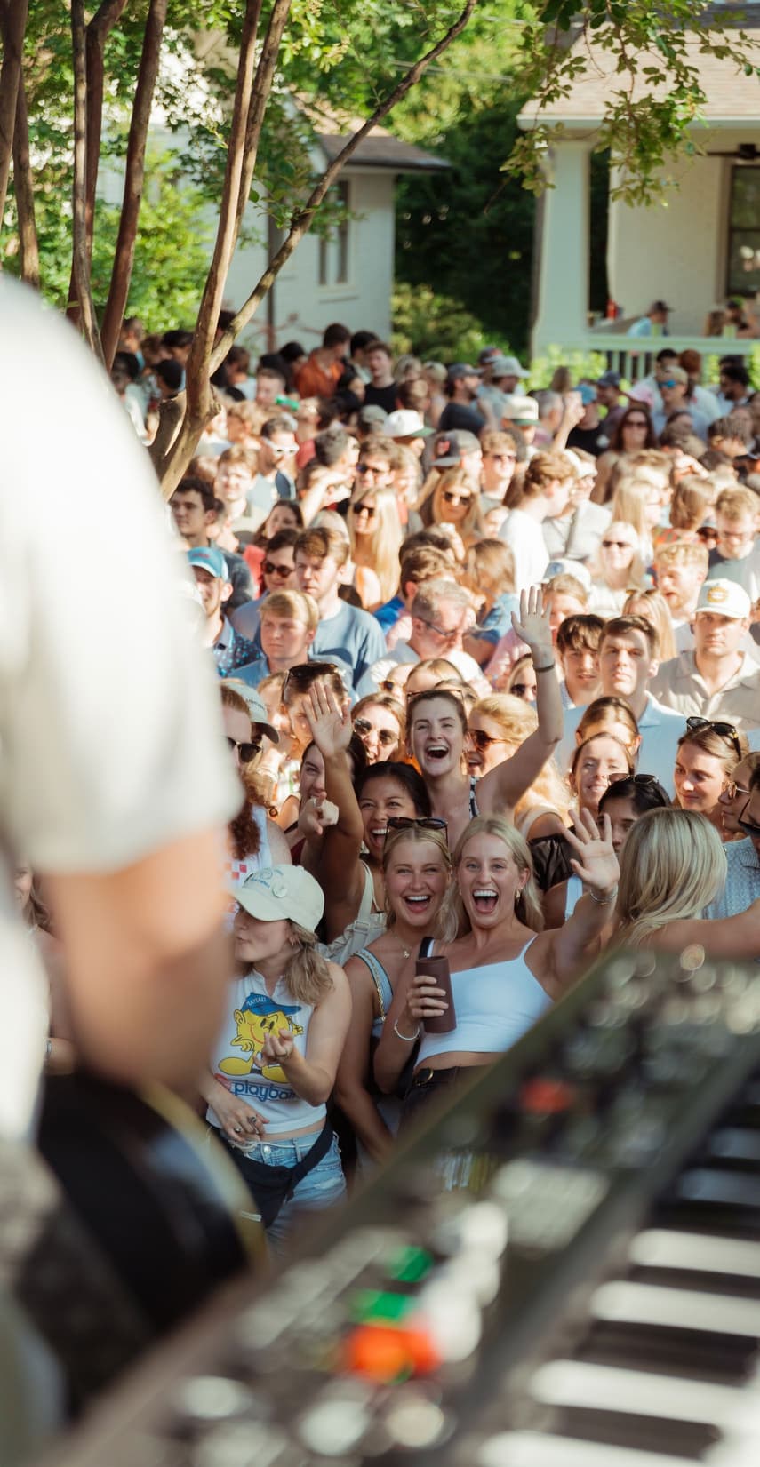 Musicians performing on a Denver porch for a packed neighborhood crowd